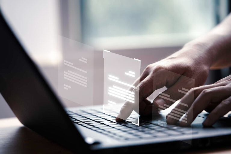 employee typing on laptop